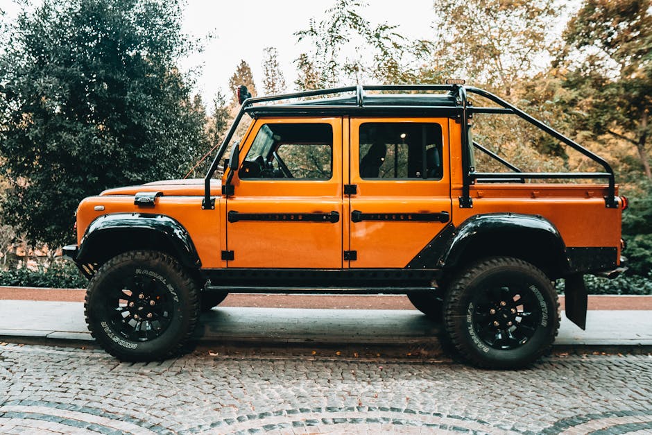 Bright orange off-road vehicle parked on a cobblestone street in Istanbul, Turkey.