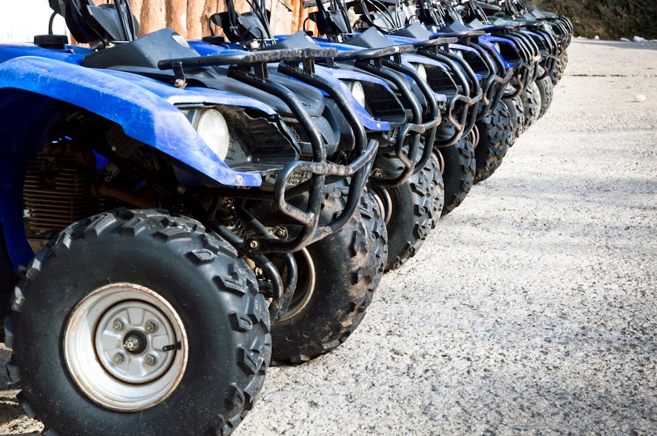 Lineup of blue ATVs parked outdoors, perfect for an off-road adventure.