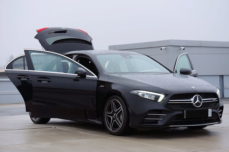 Sleek black Mercedes-Benz A35 with open doors in an urban rooftop setting, ideal for modern automotive themes