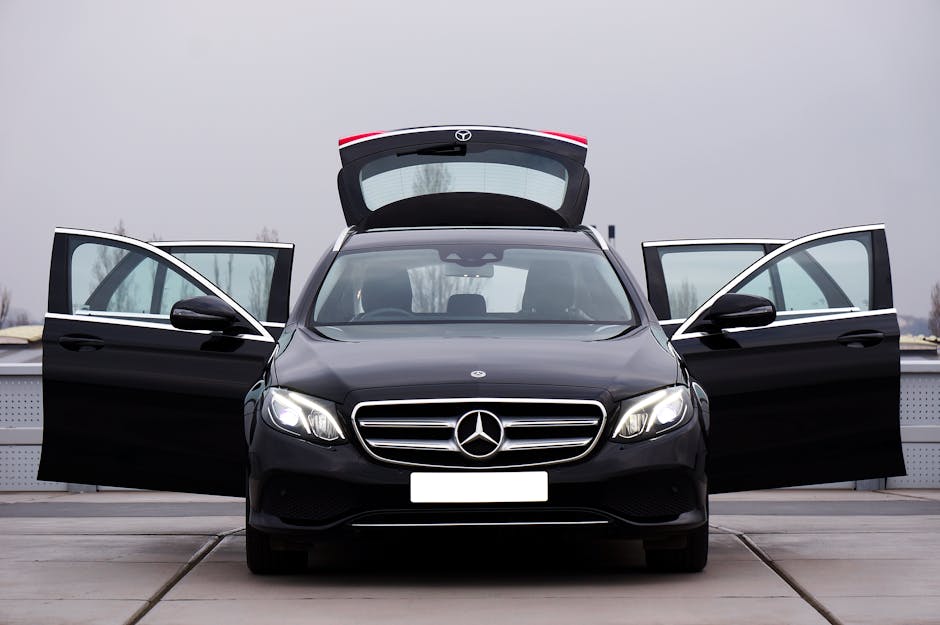 Front view of a luxury black Mercedes-Benz car with all doors and trunk open, showcasing elegance and style