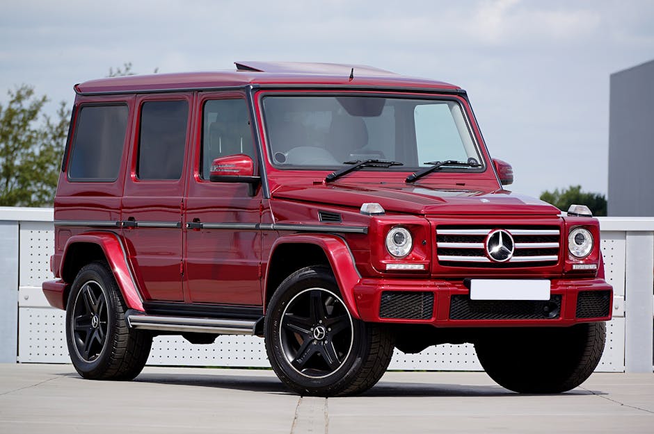 Red Mercedes-Benz G-Class SUV parked in an outdoor lot, showcasing luxury design and style